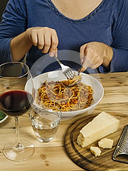 Woman eating traditional spaghetti bolognese