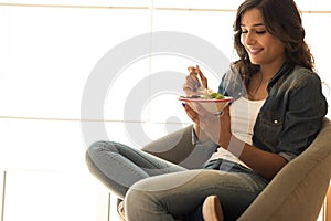 Woman eating a vegan bowl