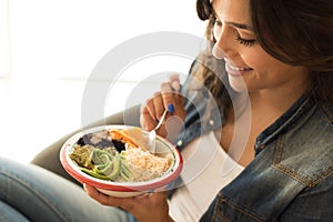 Woman eating a vegan bowl