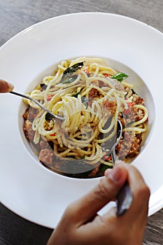 Woman eating in a white plate