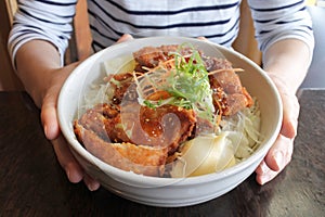 Woman eats Miso Katsu dish