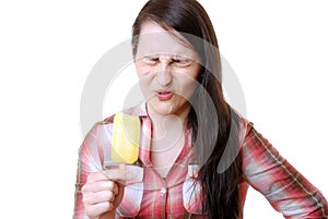 Woman eats a sour popsicle photo