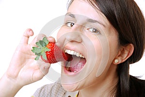 Woman eats a strawberry