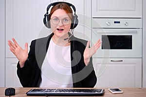 A woman is ecstatic video call at a remote job from home. Businesswoman in a suit and glasses happy, screen monitor online