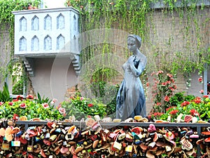 Woman eculpture and love lock fence