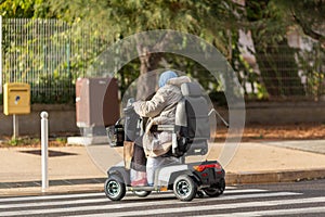 woman with an electirc wheelchair on the street