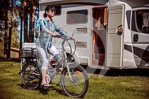 Woman on electric bike resting at the campsite