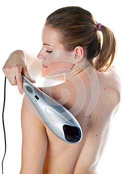 Woman with electric massager photo