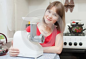 Woman with electric mincer