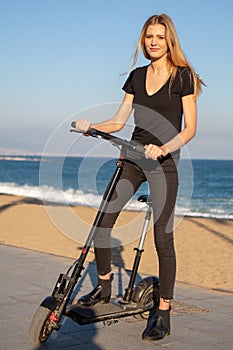 Woman with electric scooter on a sunny day