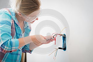 Woman electrician work at house. Professional worker