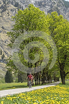 Woman on electrick Mountain bike in the Oy Tal Valley, Allgaeu Alps Below Nebelhorn