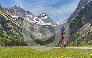 Woman on electrick Mountain bike in the Oy Tal Valley, Allgaeu Alps Below Nebelhorn