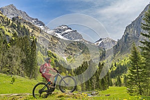 Woman on electrick Mountain bike in the Oy Tal Valley, Allgaeu Alps Below Nebelhorn