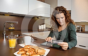Woman with electronic tablet and credit card