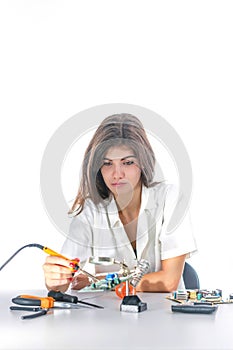 Woman Electronic Technician Repair Electronic Equipment using Electric Soldering Iron