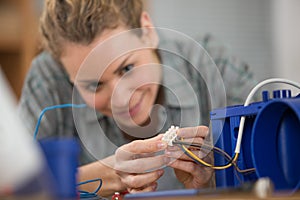 woman in electronics workshop connect wire photo