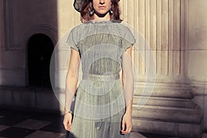 Woman in elegant dress standing in majestic hall