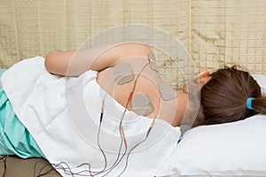 Woman with eletrical stimulator for increase muscle strength