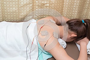 Woman with eletrical stimulator for increase muscle strength photo