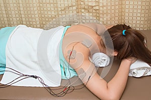Woman with eletrical stimulator for increase muscle strength photo