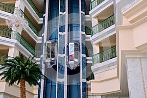 Woman in the elevator lobby of the arabic hotel. Palm tree and balconi in a hotel building in Tunisia, Africa