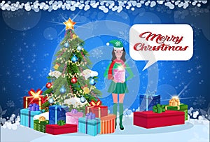 Woman elf costume holding gift box standing near fir tree happy new year merry christmas concept chat bubble flat