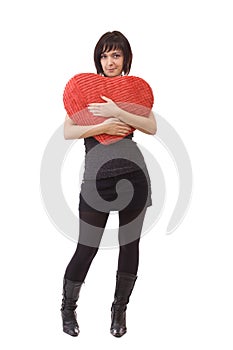 Woman embrace a heart-shape pillow