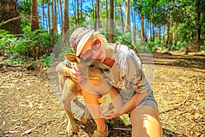 Woman embraces kangaroo