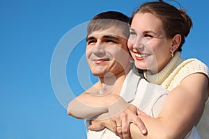 Woman embraces man from behind