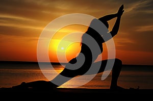 Woman embracing zen on a beach at sunset with yoga lose