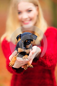 Woman embrancing her puppy dog