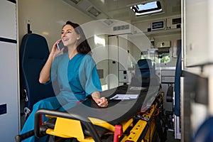 Woman from the emergency medical team speaks on the phone