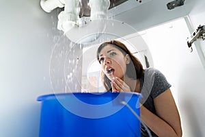 Woman With Emergency Plumbing Sink Leak photo