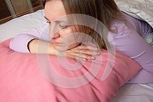 Woman emotions. Middle aged 40 years white woman portrait in the bed. Girl thinks about her life. Face expression and psychology