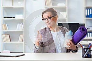 The woman employee going to sports from work during lunch break