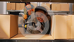 Woman employee moving products packages