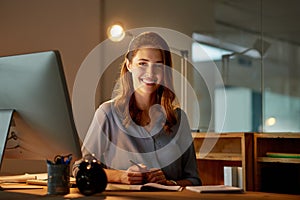 Woman, employee and smile in office with computer on work break for overtime or deadline at night. Female person