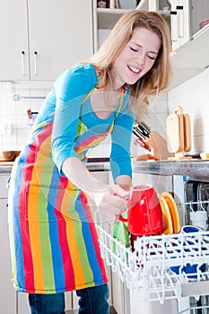 Woman emptying the dishwasher