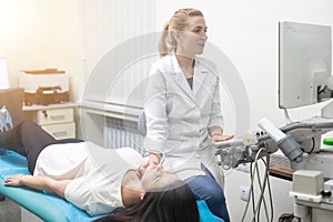 Woman endocrinologist making ultrasonography to a female patient in an ultrasound office. Ultrasound diagnostics