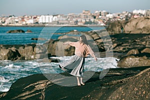 A woman is engaged in dances on the Alantic coast. photo