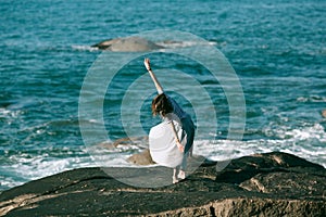 A woman is engaged in dances on the Alantic coast. photo