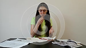 A woman is engaged in home needlework. Threading a thread into the eye of a needle. Fine motor skills. Care and accuracy.