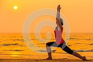 Woman engaged in yoga at sunset