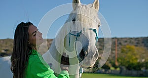 Woman engaging in loving interaction with her horse