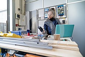 Woman engineer checking solar panel system electronics