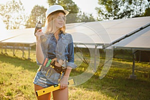 Woman engineer checking solar panels setup
