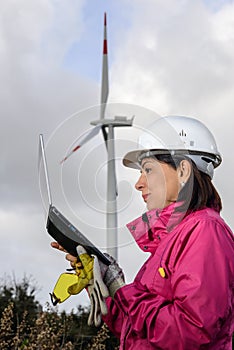 Woman engineer checking wind turbines.