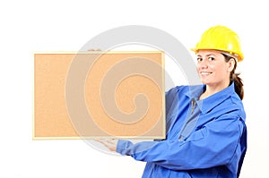 Woman engineer cork board in hand