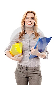 Woman engineer holding a construction plan and a helmet